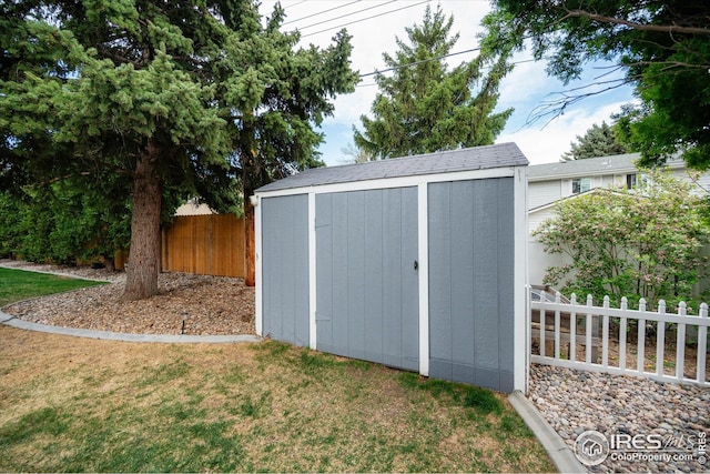 view of shed with fence