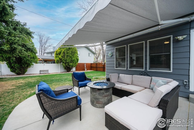 view of patio / terrace with a fenced backyard and an outdoor living space with a fire pit