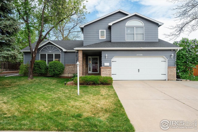 view of front of property featuring an attached garage, concrete driveway, a front yard, and brick siding
