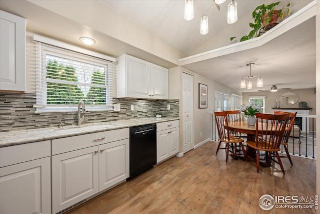 kitchen featuring a sink, dishwasher, light wood-type flooring, lofted ceiling, and tasteful backsplash