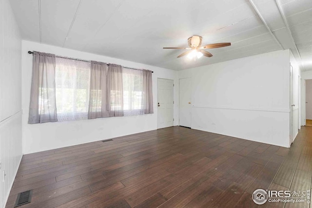 unfurnished room with visible vents, ceiling fan, and wood finished floors