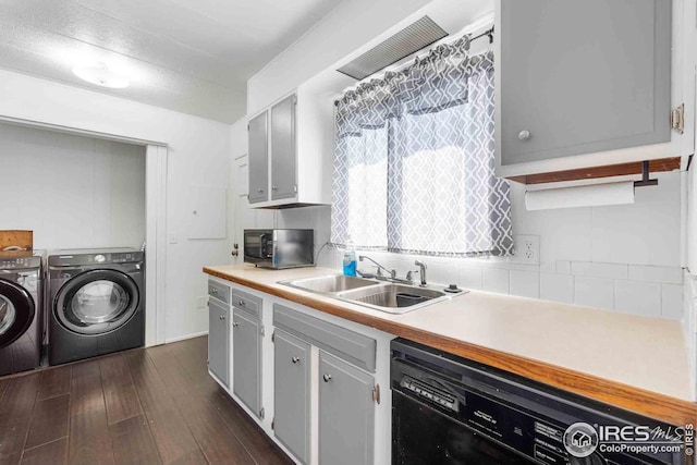 kitchen with light countertops, stainless steel microwave, separate washer and dryer, a sink, and dishwasher