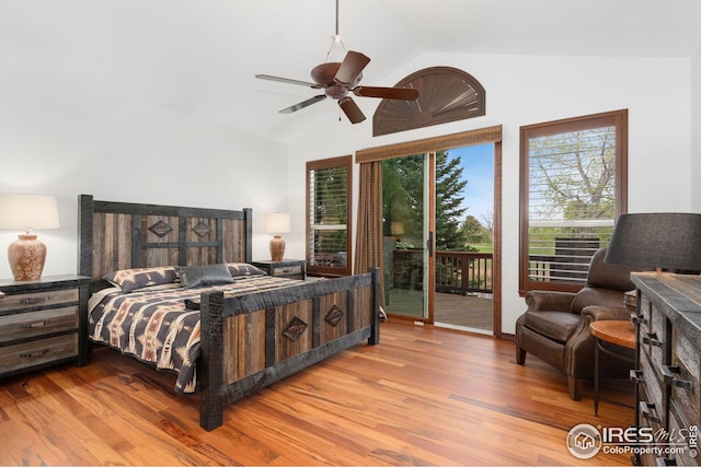 bedroom with access to outside, a ceiling fan, lofted ceiling, and wood finished floors