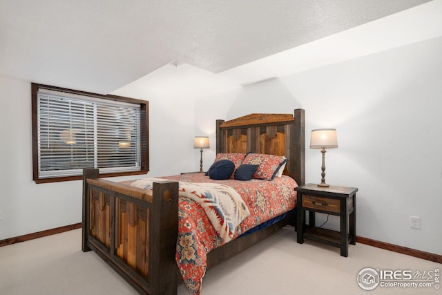 bedroom featuring baseboards and light carpet