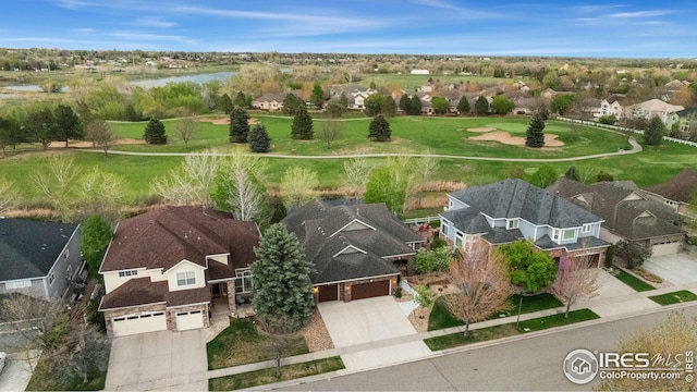 drone / aerial view featuring a residential view and a water view