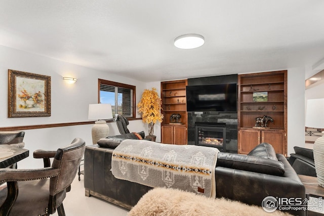 living room with a glass covered fireplace
