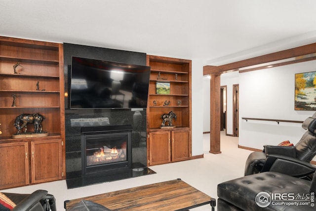 living room with built in features and a fireplace