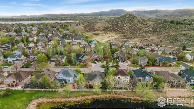 drone / aerial view featuring a residential view and a water and mountain view