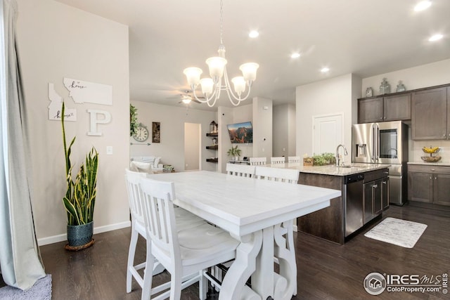 dining room featuring baseboards, recessed lighting, dark wood-style flooring, and a chandelier