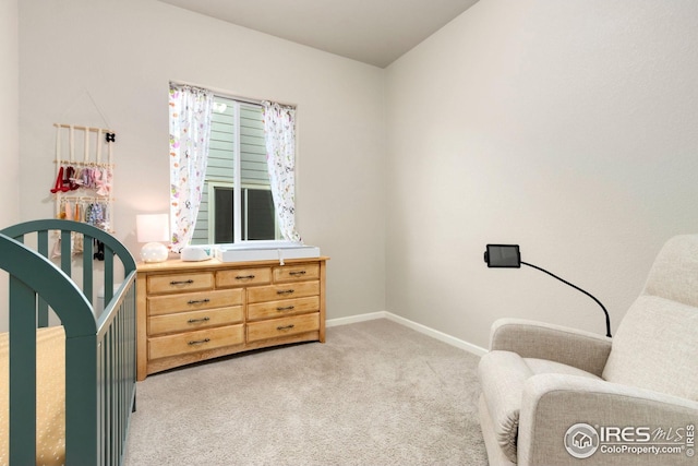 interior space featuring light colored carpet and baseboards