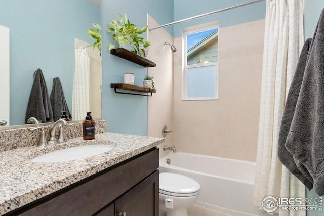 bathroom featuring vanity, shower / bath combination with curtain, and toilet