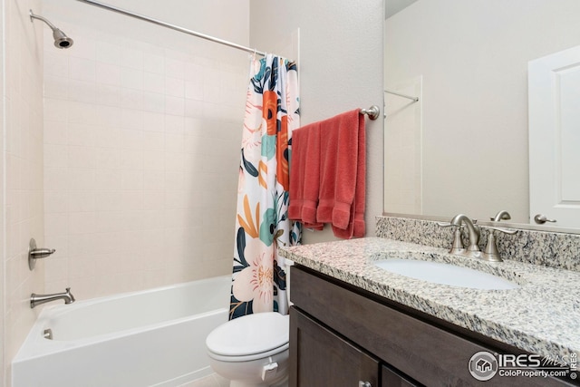 bathroom featuring shower / bath combo with shower curtain, toilet, and vanity