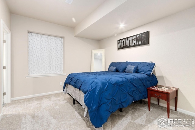 carpeted bedroom featuring baseboards