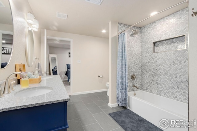 bathroom with a sink, tile patterned floors, toilet, and shower / tub combo