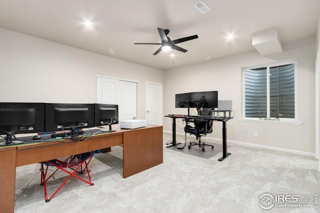 carpeted home office with baseboards, ceiling fan, and visible vents