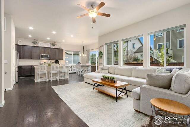 living room with recessed lighting, a ceiling fan, baseboards, and dark wood-style floors