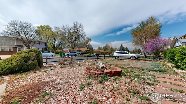 view of yard featuring fence and a residential view