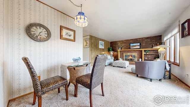dining area with a brick fireplace and carpet