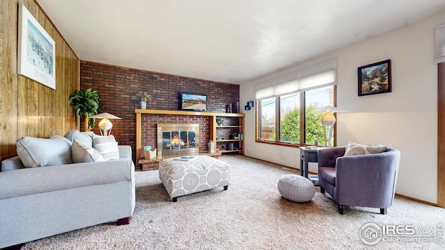 living area with carpet floors, baseboards, and a fireplace