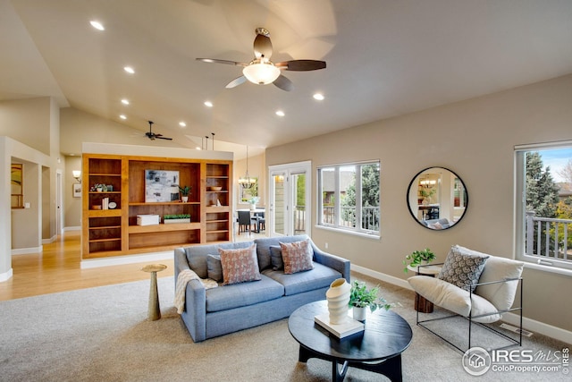 living area with ceiling fan, light colored carpet, vaulted ceiling, baseboards, and recessed lighting