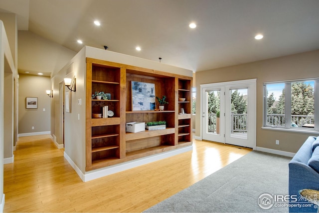living room featuring recessed lighting, baseboards, and light wood finished floors