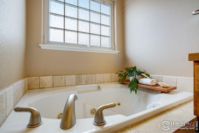 full bath featuring a tub with jets