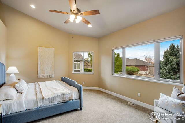 carpeted bedroom featuring baseboards, ceiling fan, and vaulted ceiling