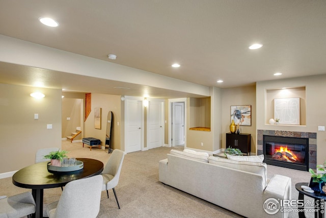 living room with stairs, light carpet, baseboards, recessed lighting, and a tiled fireplace