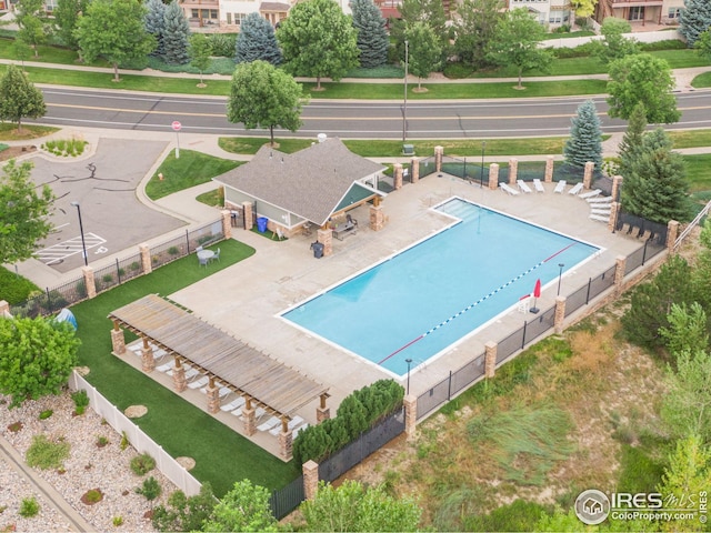pool with fence and a patio