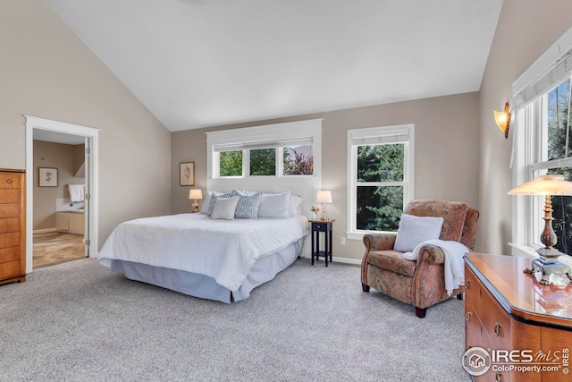 bedroom with light colored carpet, connected bathroom, and baseboards