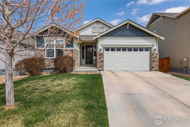 craftsman house featuring a garage, driveway, a front yard, and stone siding