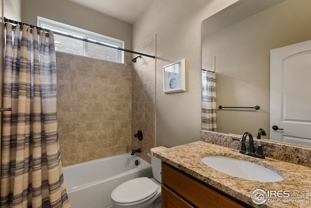 bathroom featuring vanity, a textured wall, toilet, and shower / bathtub combination with curtain