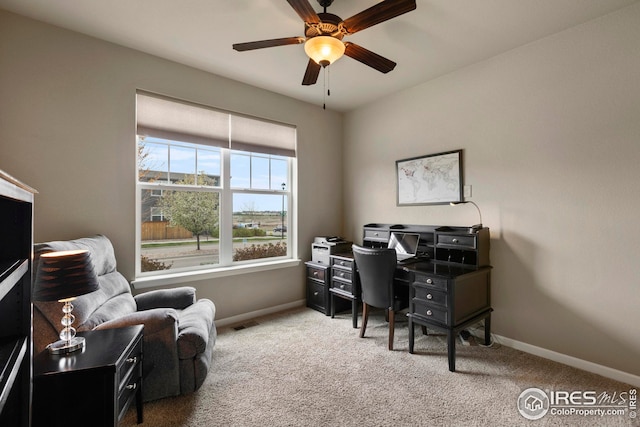 carpeted office featuring baseboards, a ceiling fan, and visible vents
