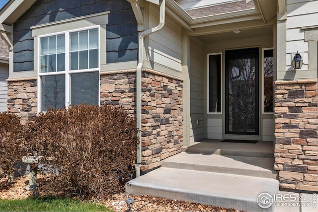 entrance to property with stone siding