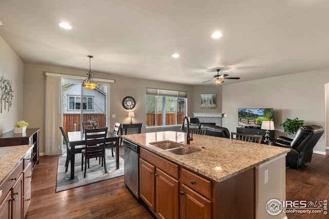 kitchen featuring dark wood-type flooring, a sink, ceiling fan, and dishwasher