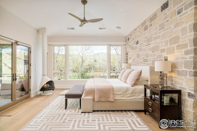 bedroom with visible vents, multiple windows, and access to exterior