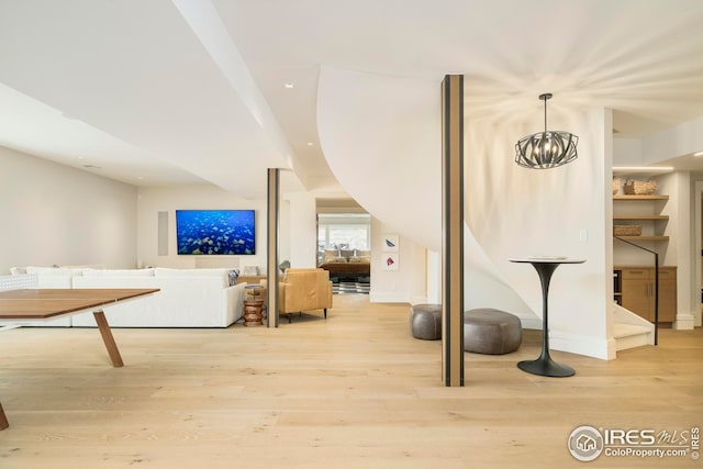 bonus room with recessed lighting, light wood-type flooring, and a notable chandelier
