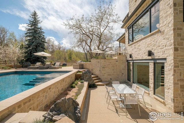 pool with a patio and stairs