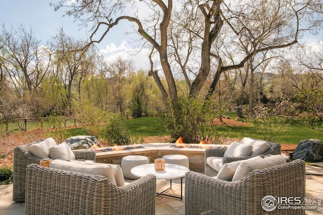 view of patio / terrace featuring an outdoor living space with a fire pit