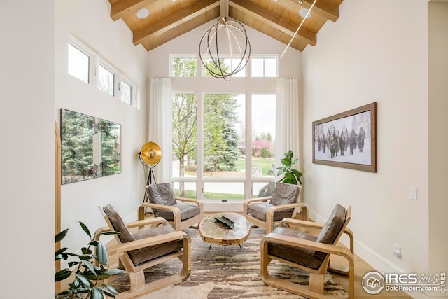 living area with wood finished floors, beam ceiling, high vaulted ceiling, and wooden ceiling