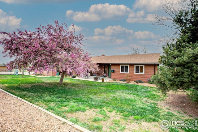 view of front of property with a front lawn and a patio area