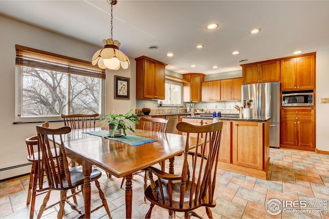 dining room with baseboards, recessed lighting, and stone tile flooring