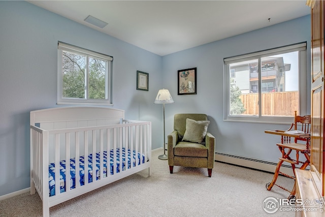 bedroom with carpet floors, a baseboard heating unit, multiple windows, and visible vents