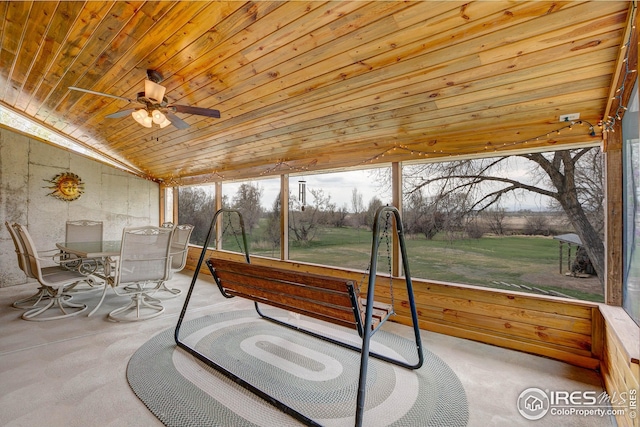 sunroom / solarium featuring ceiling fan and outdoor dining area