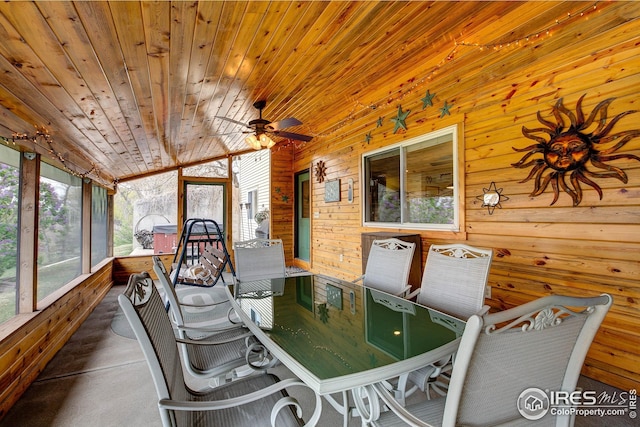 sunroom / solarium with wooden walls, wooden ceiling, and ceiling fan