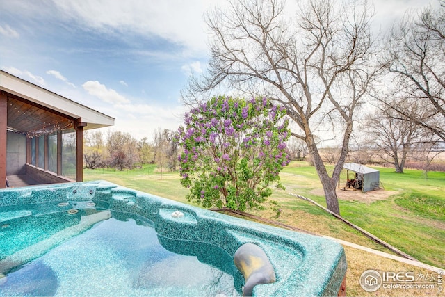 view of pool with a lawn