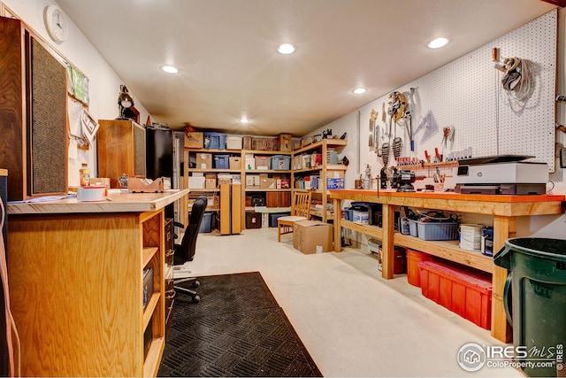 office space with recessed lighting and a workshop area