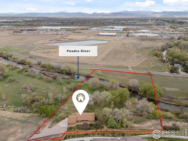 birds eye view of property with a rural view and a water and mountain view