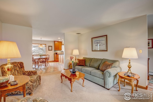 living room featuring light colored carpet and baseboards