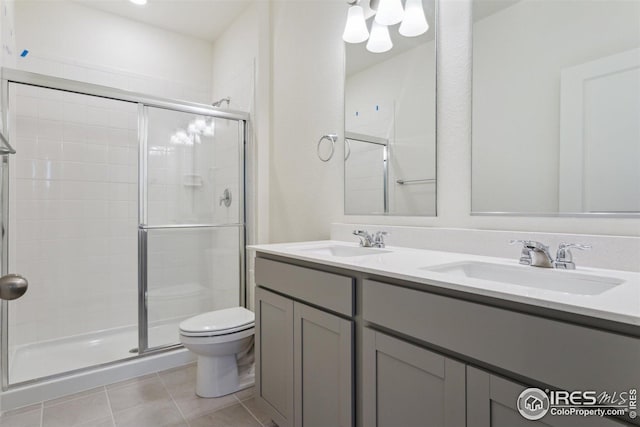6500 13th St, Frederick, CO 80530 - full bathroom featuring toilet, tile patterned floors, a shower stall, and a sink